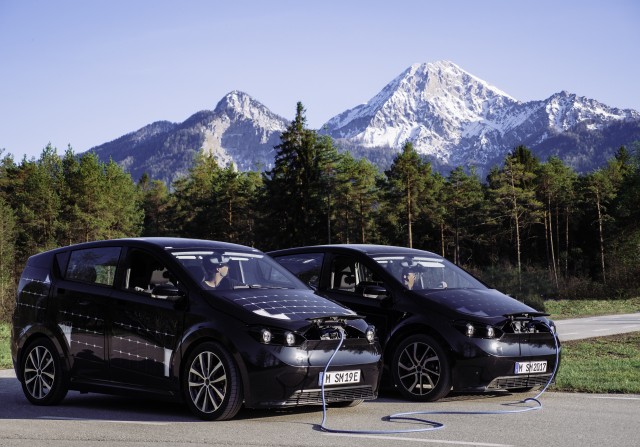 Two Sion solar cars by Sono Motors. One cars shares energy with the other one via the biSono System.